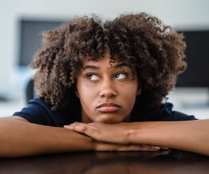 bored woman with her head on her hands