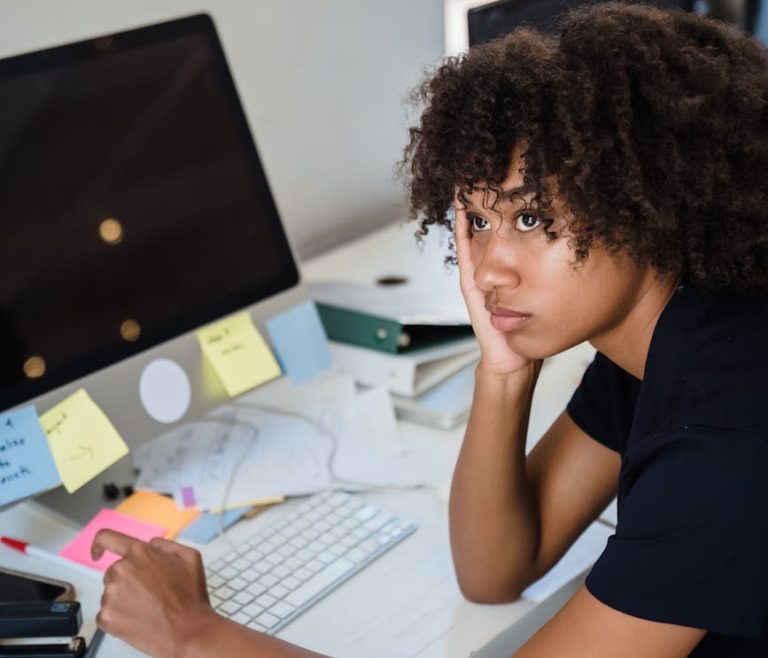 tired woman sitting by work desk
