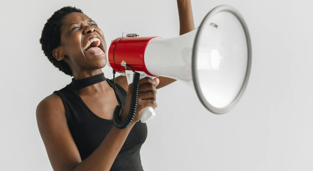 a woman shouting on a megaphone