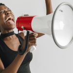 a woman shouting on a megaphone